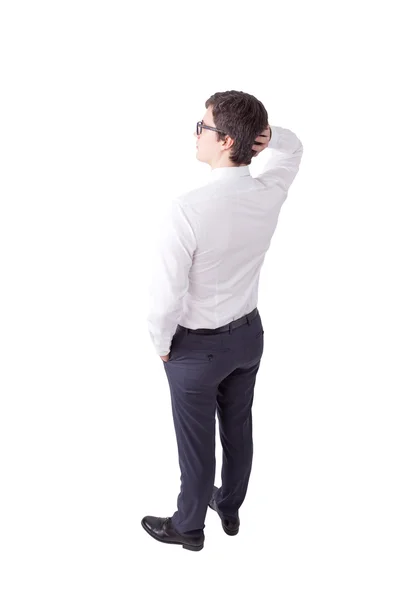 Young businessman in glasses standing with hand on head, thinking. — Stock fotografie