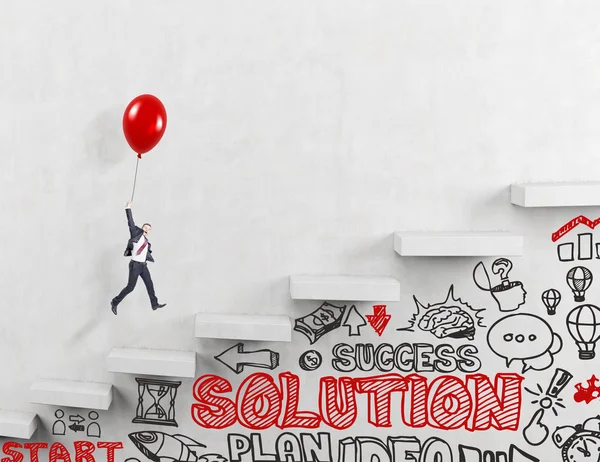 Üzletember repülő az emeleten a piros léggömb, az üzleti ikonok és szavak alatt. Betonozott háttér. — Stock Fotó