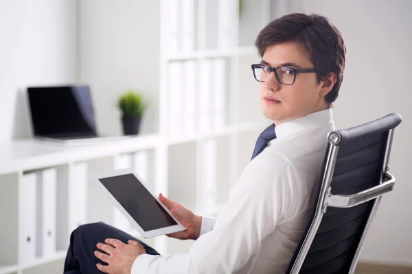 Businessman with tablet on chair — Stock Photo, Image