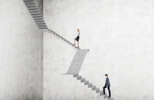 Empresaria subiendo escaleras empinadas, hombre de negocios tras ella. Fondo de hormigón. Concepto de crecimiento profesional . —  Fotos de Stock