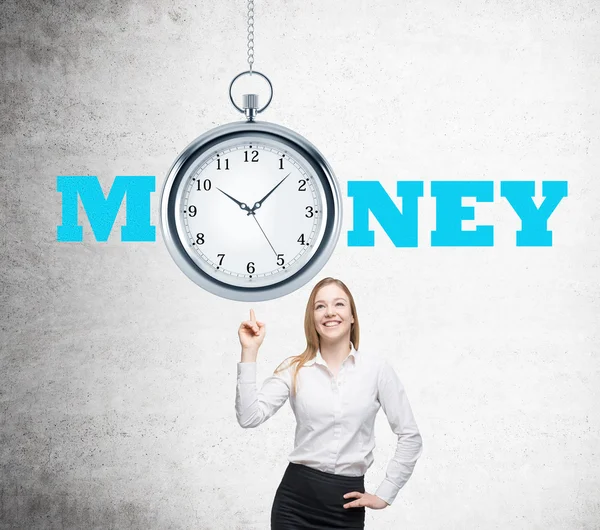 Businesswoman with finger up, pocket watch over her. Concrete wall. Concept of time is money. — Stock Photo, Image