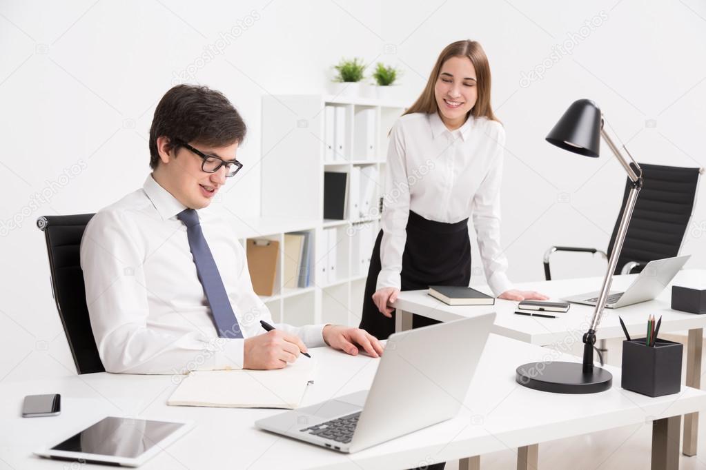Businessman and businesswoman in office