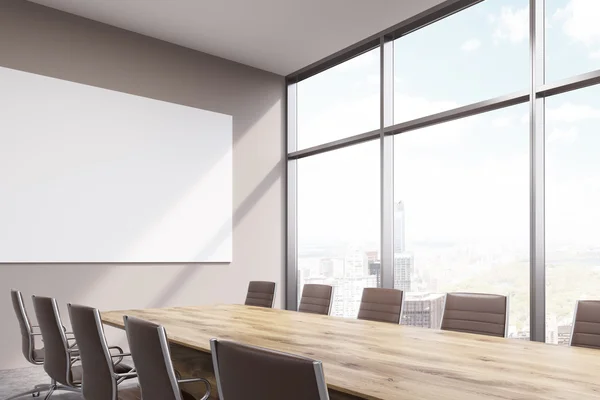 Spacious meeting room, window to the right, big white poster over table. — Stock Photo, Image