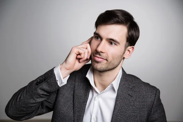 Portrait of business with phone on light background — Stok Foto