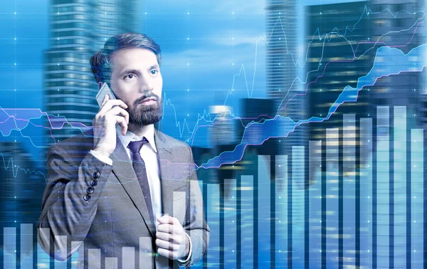 Businessman on phone charts — Stock Photo, Image