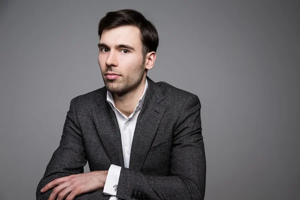 Serious man in suit on dark background — Stock Photo, Image