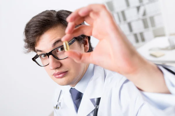 Young doctor with pill — Stock Photo, Image