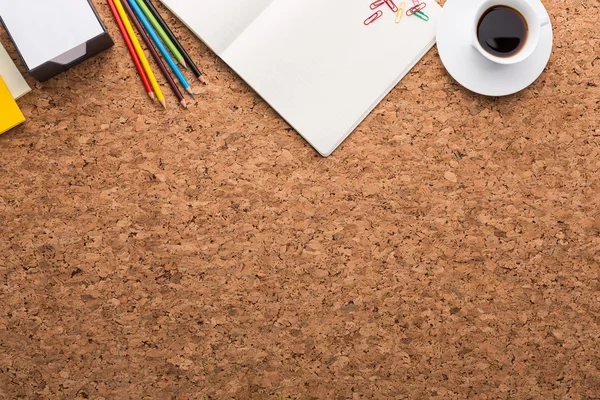 Topview of cork table with blank notepad, coffee cup, pencils and other items. Mock up — Stock Photo, Image
