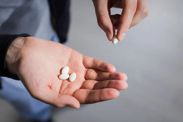 Taking pill from palm — Stock Photo, Image