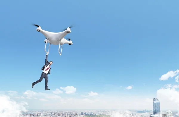 Businessman flying with quadrocopter — Stock Photo, Image