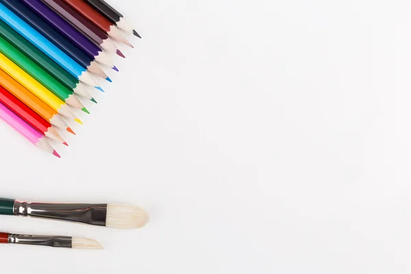 Colorful pencils and paintbrushes — Stock Photo, Image