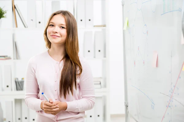 Smiling woman near office whiteboard — Stock Photo, Image