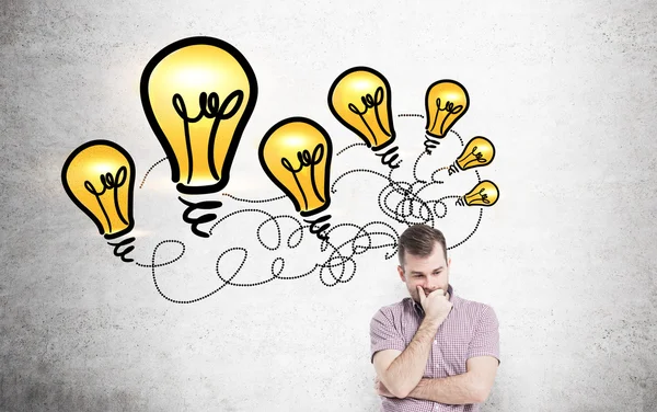 Casual man with lightbulb drawings — Stock Photo, Image