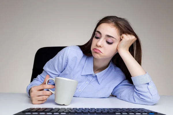 Bored woman looking into cup — Stock Photo, Image