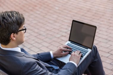 Yakışıklı işadamı dizüstü bilgisayar tarafı kullanarak