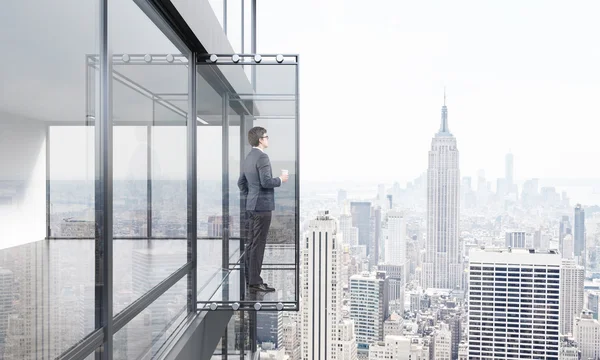 Businessman with coffee on balcony — Stock Photo, Image