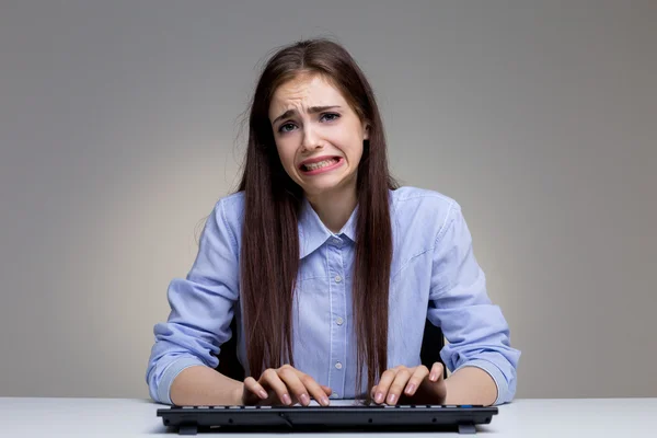 Funny regretful woman using keyboard — Stock Photo, Image