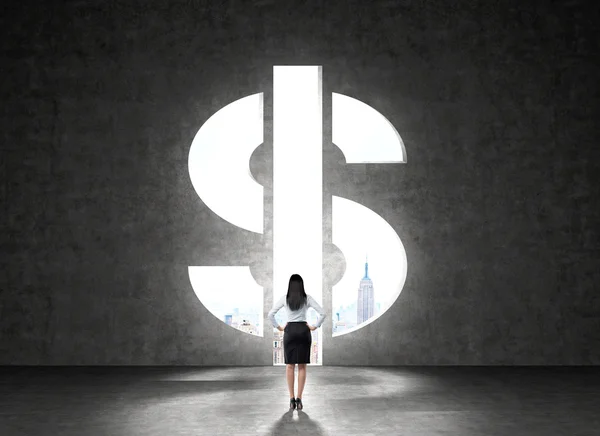 Businesswoman in front of wall with dollar symbol — Stock Photo, Image