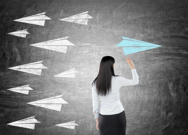 Woman drawing paper plane — Stock Photo, Image