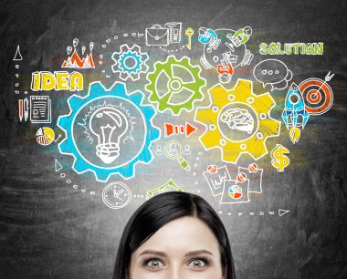 Woman looking at viewer near chalkboard