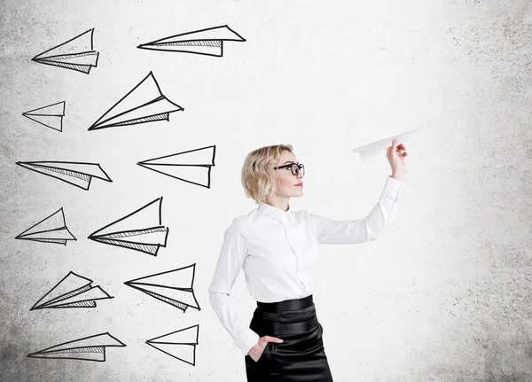 Blond woman with paper plane — Stock Photo, Image