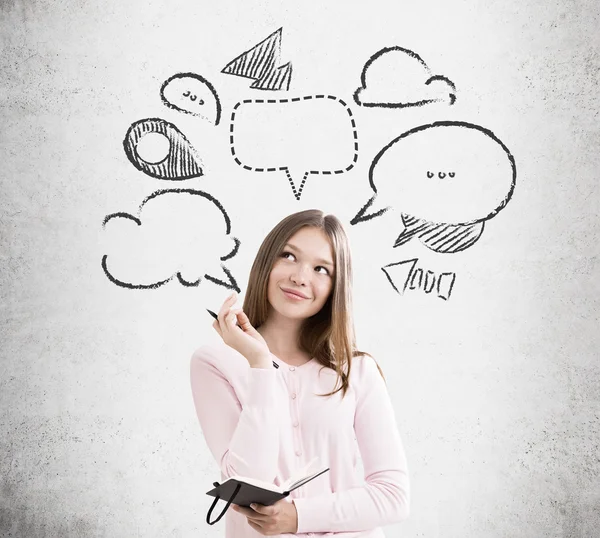 Young lady near concrete wall with sketches — Stok fotoğraf