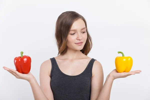 Slim girl with bell peppers — Stock Photo, Image