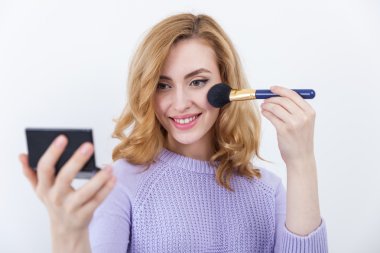 woman holding brush and powder