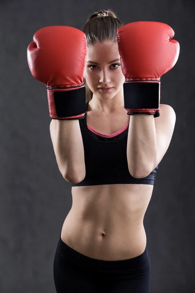 Woman boxer in red gloves