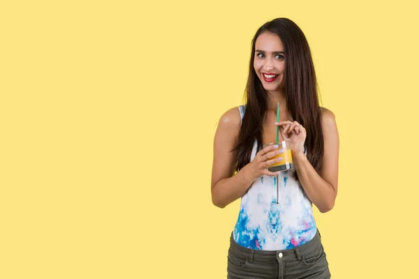 Girl in colorfull tank top drinking juice — Stok Foto