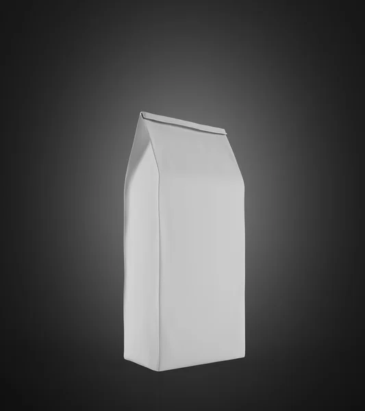 White lunch paper bag standing on black surface — Stok fotoğraf