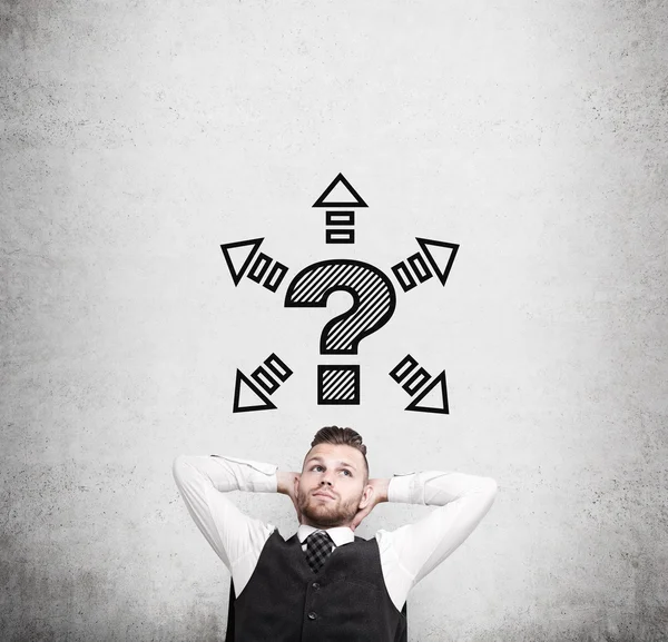 Sitting businessman and question mark with arrows — Stock Photo, Image