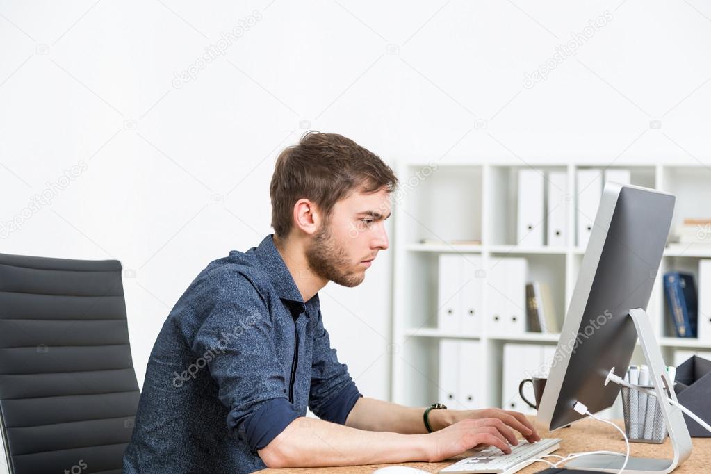 Man typing in office