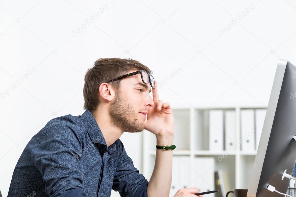 Man in glasses making decision