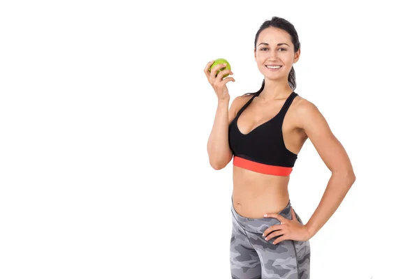 Chica sonriente en ropa deportiva con una manzana — Foto de Stock