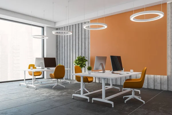 Corner of modern open space office with orange and gray walls, tiled floor and big computer tables with orange chairs. 3d rendering