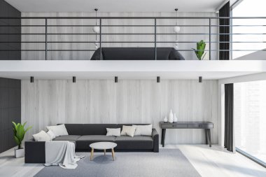 Oturma odasında büyük gri bir kanepe ve ikinci katta iki katlı bir yatak var. 3 boyutlu büyük salon, şık minimalist mobilyalar ve büyük pencereli, insan yok.