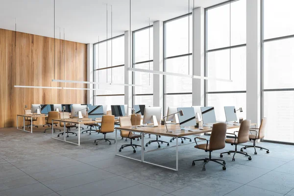 Open space office, wooden desks with computers. Stylish modern new tables with computers in a row, work space in office, no people, 3D rendering
