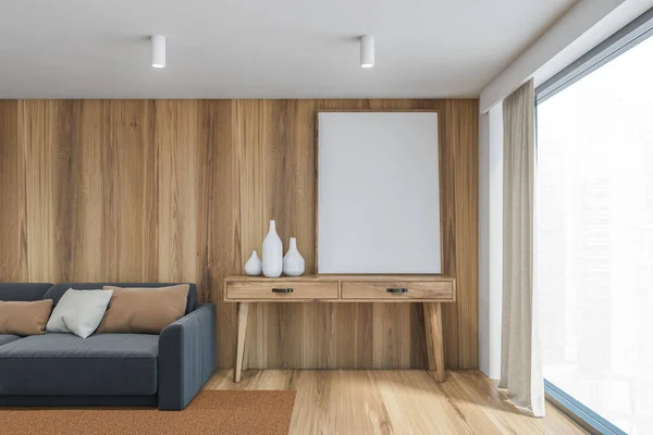 Light wood living room with grey sofa with pillows, against brown wooden wall. Blank mockup canvas on the table near a big window, 3D rendering illustration of a modern stylish room