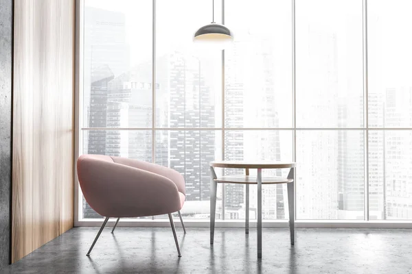 Pink chair with in the corner with a pendant lamp of office interior near big glass window, grey floor city view on skyscrapers. Comfortable light rest room 3D rendering, no people