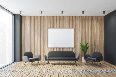 Gri ahşap salonda iki gri koltuk, uzun kanepe, ahşap duvar ve çakıl döşemeli halı bulunan bir model tuval. Büyük pencereli minimalist oturma odası, insan yok.