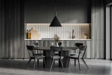 Gri ve ahşap duvarları, beton zemini, ahşap dolapları ve yemek masası olan modern mutfağın içi. 3d oluşturma