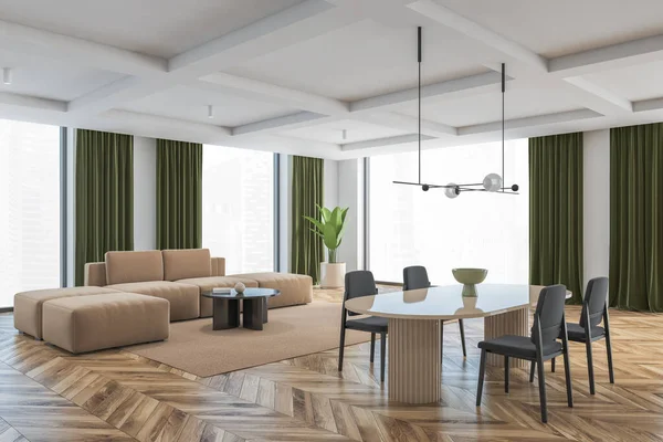 Big living room with grey chairs, brown table and brown sofa on background. Large windows in big hall with green curtains, light wooden parquet floor and white walls, 3D rendering no people