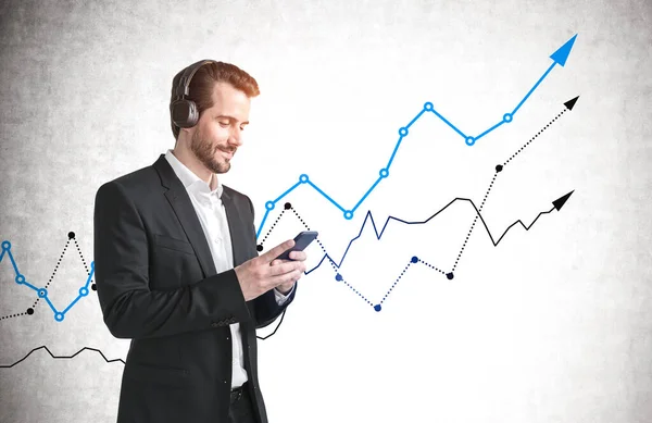 Young Businessman Using Smartphone Concrete Wall Growing Graphs Concept Investment — Stock Photo, Image