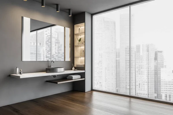 Grey bathroom, sink and big mirror with shelves. Open space bathroom with wooden floor and a big window with view on skyscrapers, 3D rendering no people