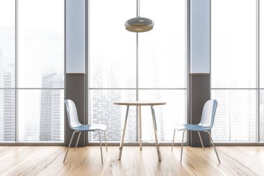 Gökdelenlerde şehir manzaralı, pencerenin yanında iki sandalyeli bir kafe. Ahşap zeminli, modern minimalist kafenin mavi ve gri iç mimarisi.