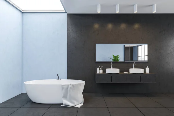 Blue and black walls, minimalist design of bathroom, two white sinks with mirror on black wall, white bathtub with towel, black tiled floor. Window on the ceiling, 3D rendering no people