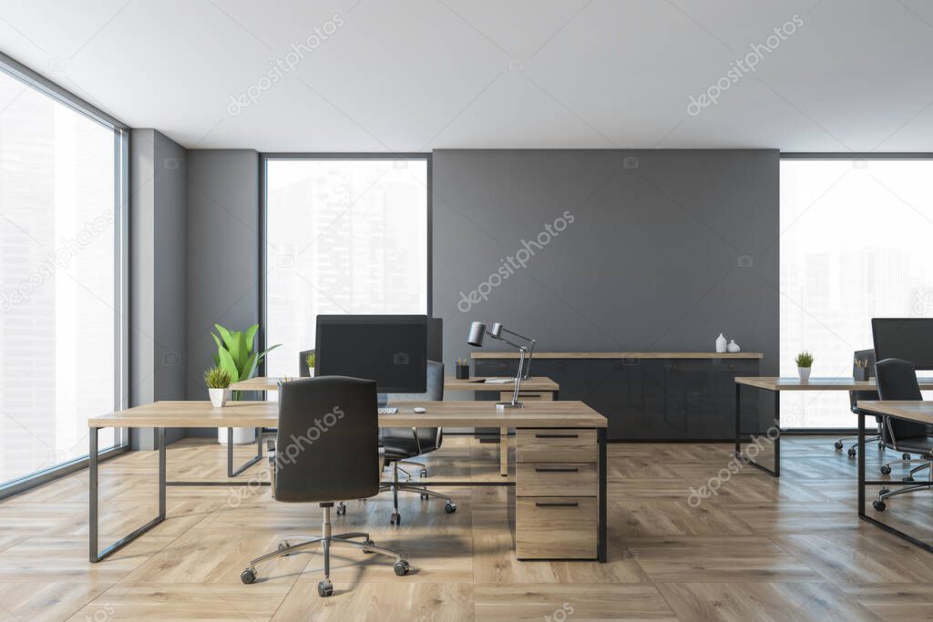 Grey and wooden office room with computers on tables and black chairs. Open space workplace with modern furniture on parquet floor, 3D rendering no people