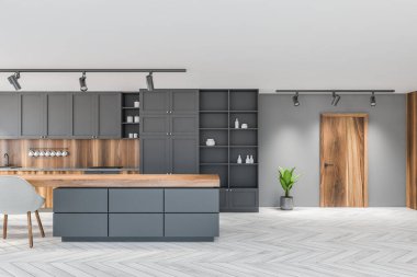 Beyaz ve gri duvarları, ahşap zemini, gri dolapları ve yemek masası olan şık bir mutfak. Tahta kapı. 3d oluşturma