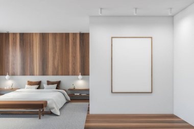 Beyaz duvara boş bir çerçeve. Tahta minimalist dizaynlı. Kahverengi yastıklı beyaz yatak odası, parke zemin. Gri ve ahşap duvarlar 3 boyutlu, insan yok.